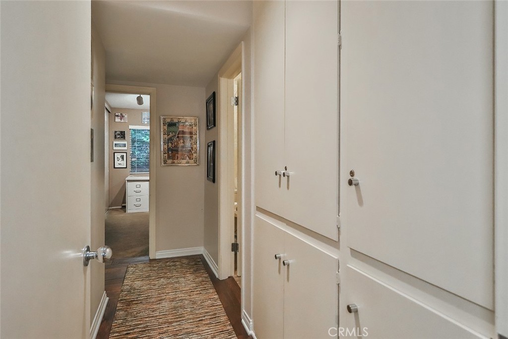 4575 De Celis Place Encino, CA 91436 - Photo 30 of 63 a view of a hallway with wooden floor and a bathroom