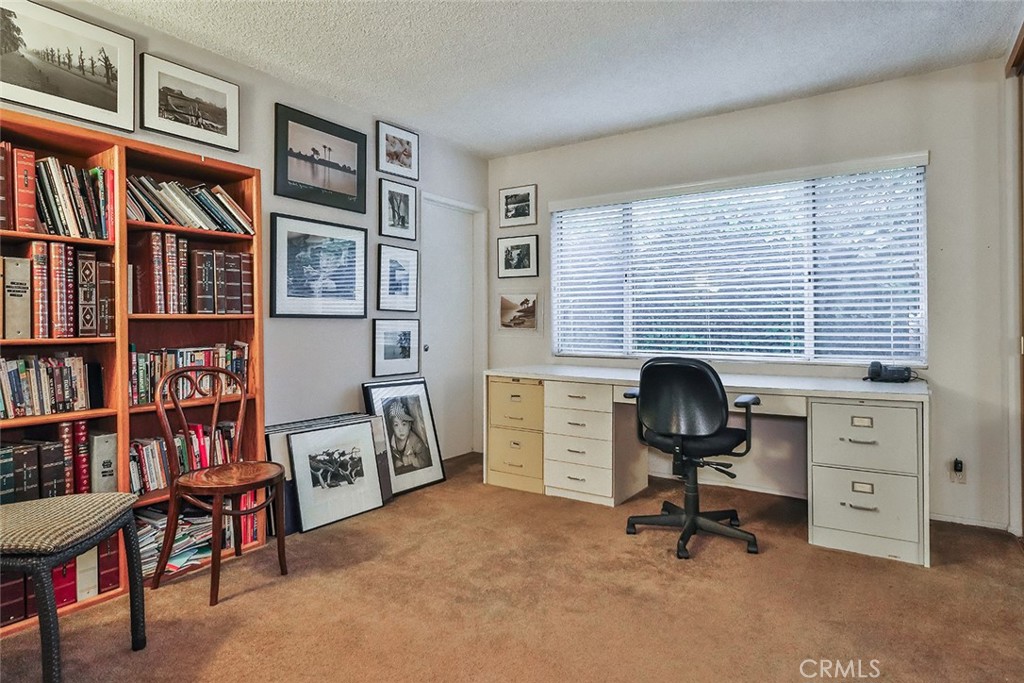 4575 De Celis Place Encino, CA 91436 - Photo 32 of 63 a view of a workspace with bookshelf