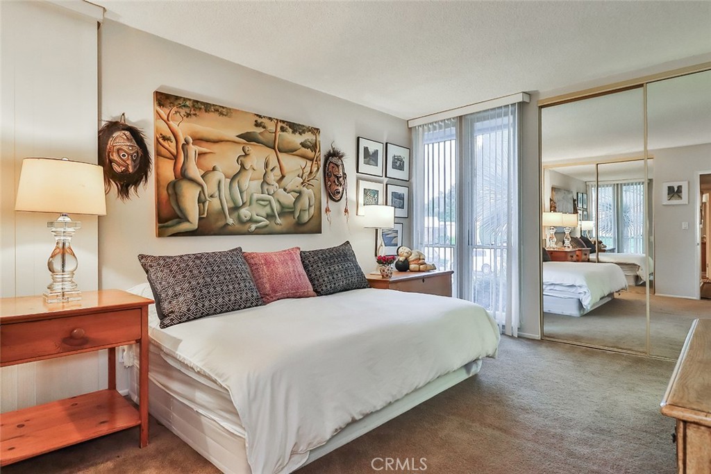 4575 De Celis Place Encino, CA 91436 - Photo 34 of 63 a bedroom with a large bed and a painting on the wall