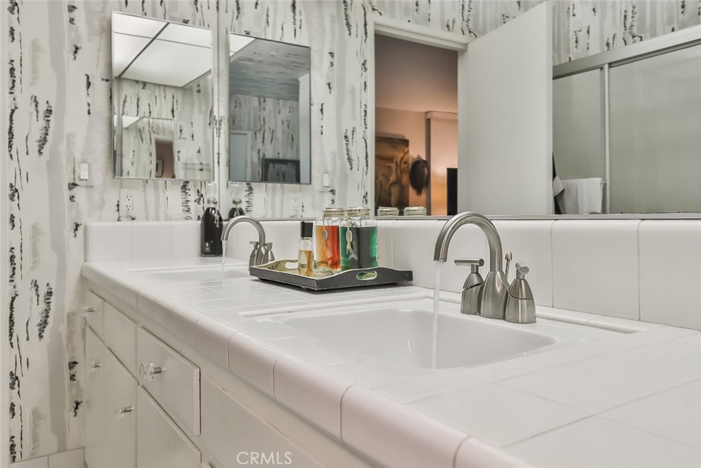 4575 De Celis Place Encino, CA 91436 - Photo 37 of 63 a bathroom with double vanity sink and a mirror