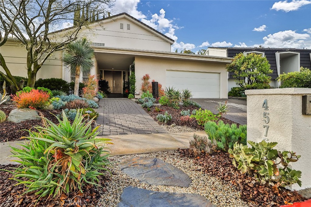4575 De Celis Place Encino, CA 91436 - Photo 4 of 63 a front view of a house with a yard