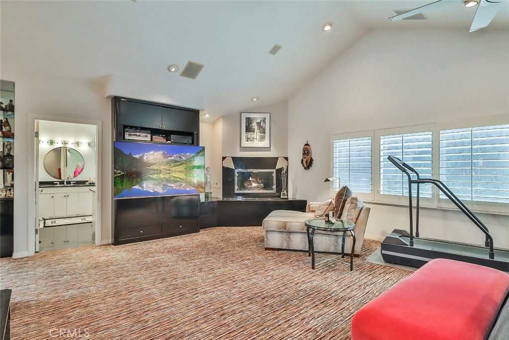4575 De Celis Place Encino, CA 91436 - Photo 43 of 63 a living room with furniture flat screen tv and a fireplace