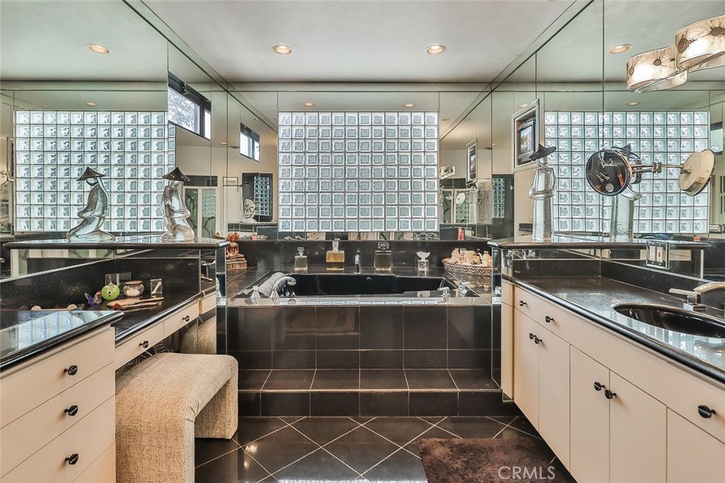 4575 De Celis Place Encino, CA 91436 - Photo 49 of 63 a kitchen with a sink and wooden cabinets