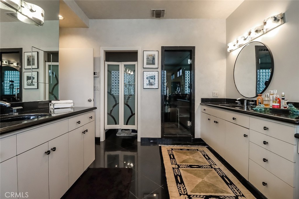 4575 De Celis Place Encino, CA 91436 - Photo 53 of 63 a bathroom with a double vanity sink and a mirror