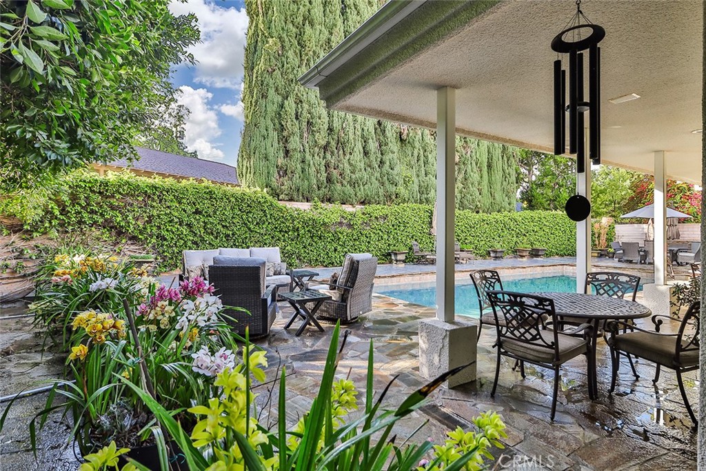 4575 De Celis Place Encino, CA 91436 - Photo 60 of 63 a view of a patio with table and chairs potted plants