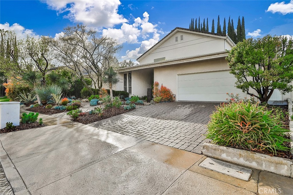 4575 De Celis Place Encino, CA 91436 - Photo 6 of 63 a front view of a house with garden