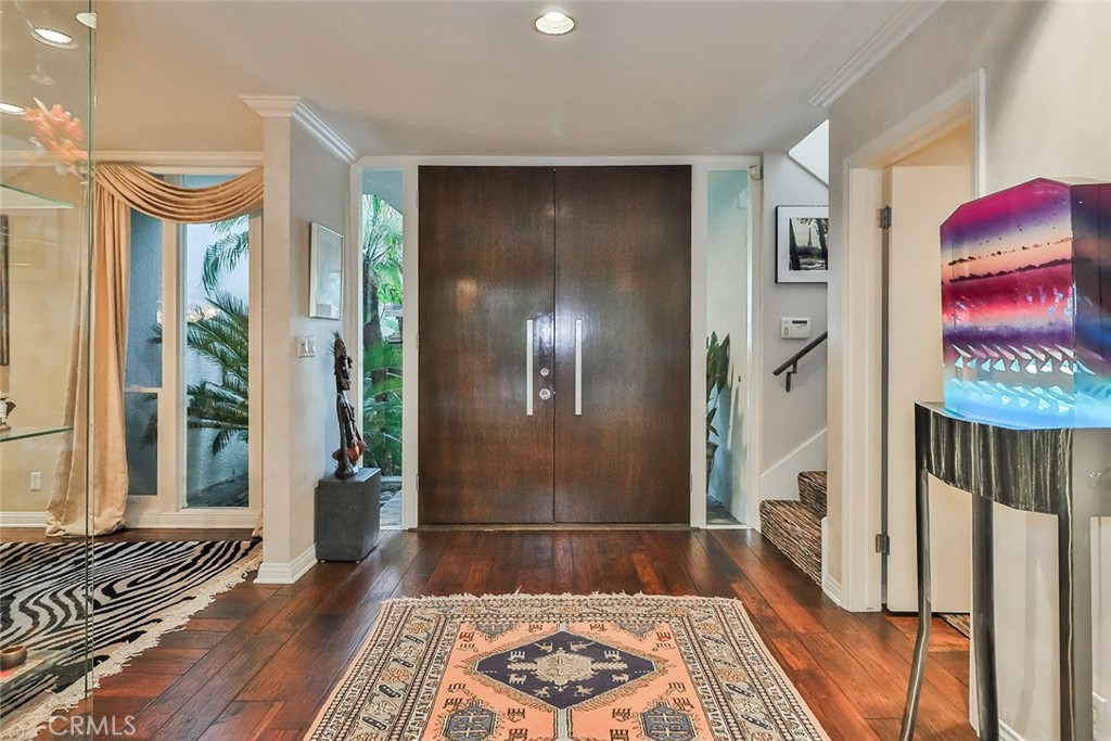 4575 De Celis Place Encino, CA 91436 - Photo 10 of 63 a view of a hallway with wooden floor and a rug
