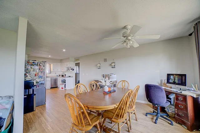a view of a dining room with furniture and wooden floor