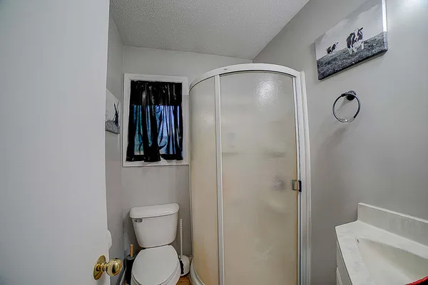 a bathroom with a toilet and a shower