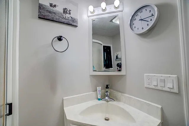a bathroom with a sink and a mirror