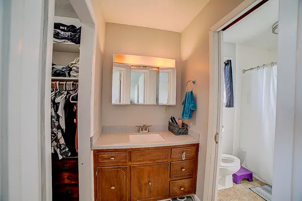 a bathroom with a sink toilet and shower