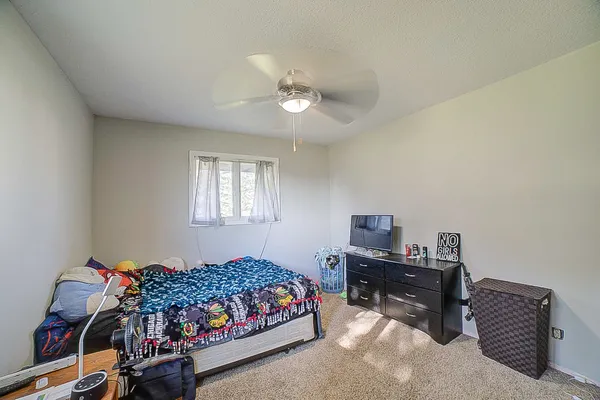 a bedroom with a bed and a chandelier
