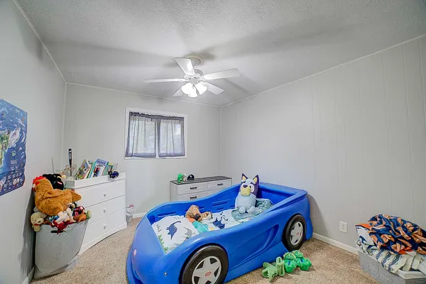 a utility room with toys and ceiling fan