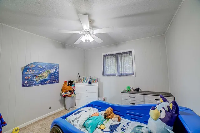 a bed room with a bed and a chandelier