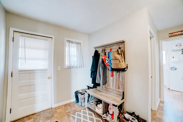 a view of a storage and utility room with closet wooden floor