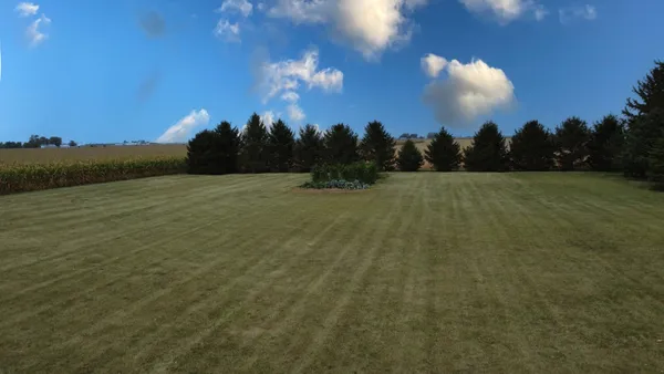 a backyard of a house with lots of green space