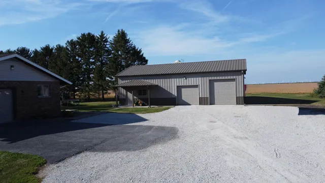 a front view of house with yard and trees in the background