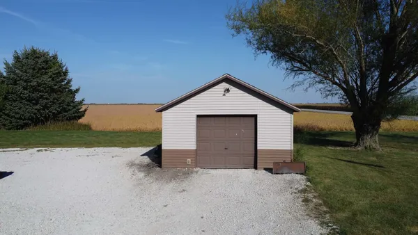a view of a house with a yard and garage