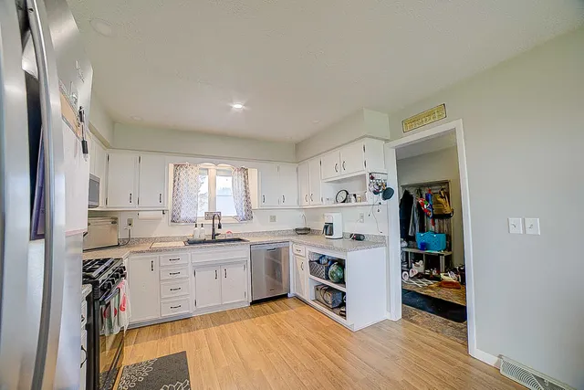 a kitchen with a sink a stove and cabinets
