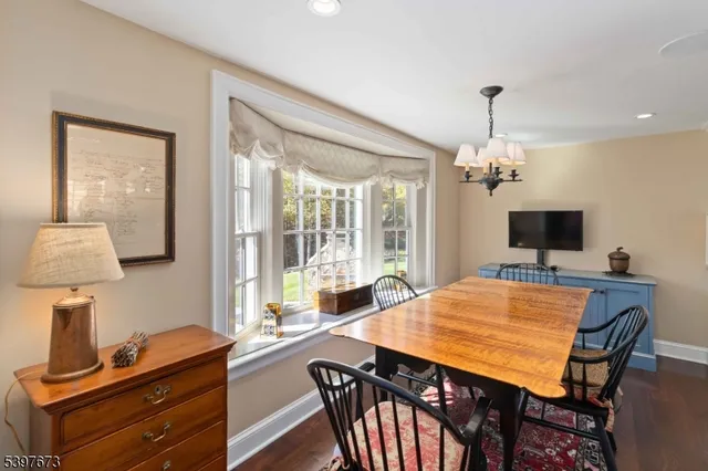 a view of a dining room with furniture a chandelier and wooden floor