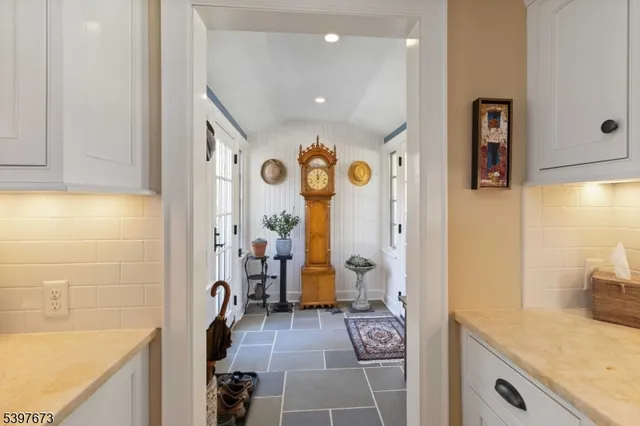 a bathroom with a granite countertop sink a mirror and shower
