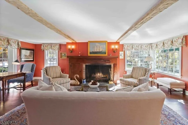 a living room with furniture a large window and a fireplace