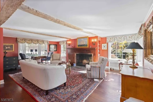 a living room with furniture a fireplace and a large window