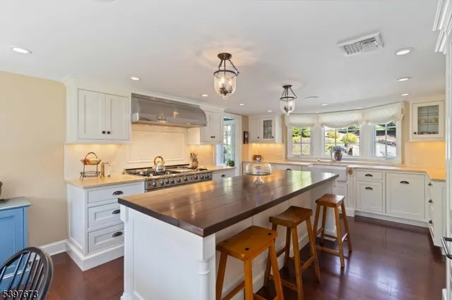 a kitchen with granite countertop a sink a center island and stainless steel appliances