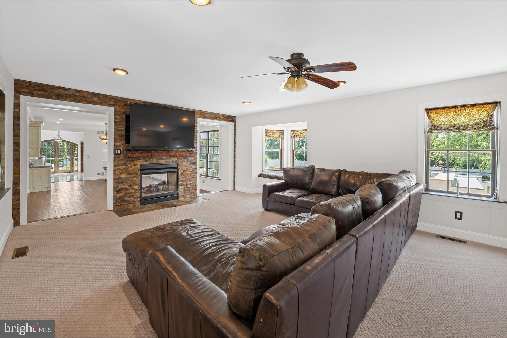 2159 McCoy Road Bear, DE 19701 - Photo 28 of 110 a living room with furniture a flat screen tv and a fireplace