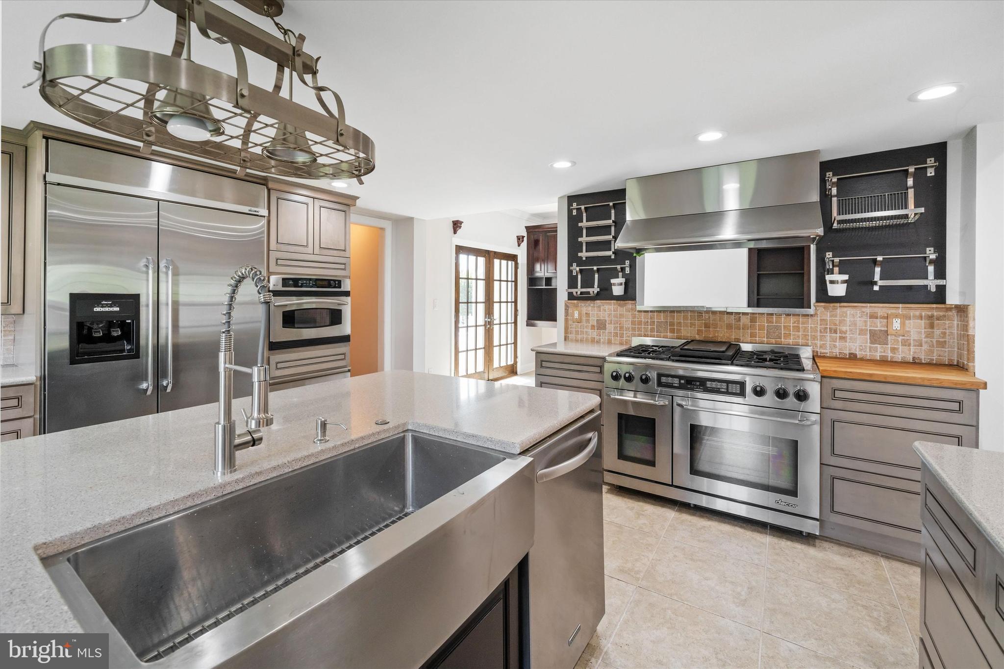 2159 McCoy Road Bear, DE 19701 - Photo 32 of 110 a kitchen with stainless steel appliances granite countertop a stove and a refrigerator