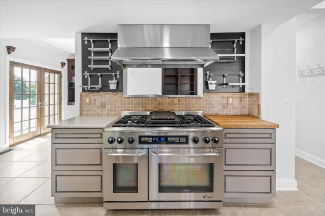 a living room with hard wood floors and a ceiling fan