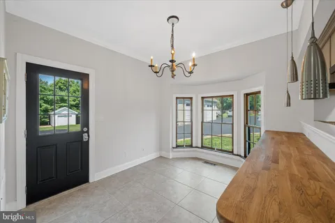 an aerial view of a house with garden space and street view