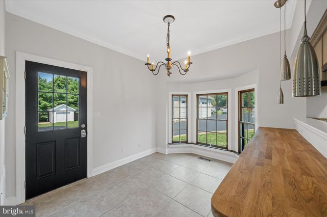 an aerial view of a house with garden space and street view