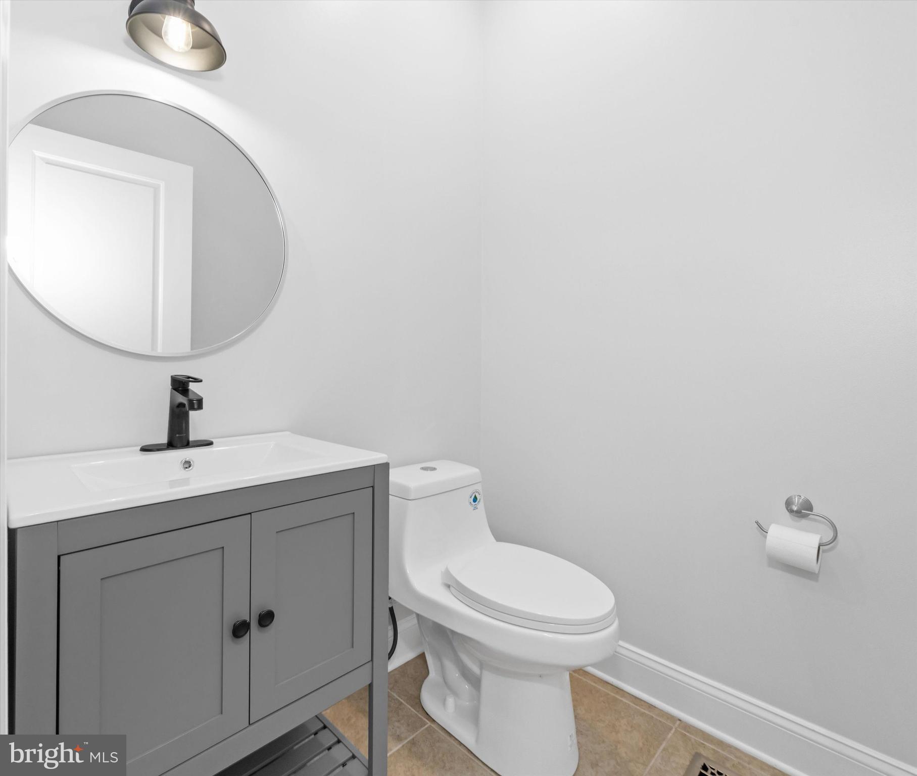 2159 McCoy Road Bear, DE 19701 - Photo 42 of 110 a bathroom with a toilet a sink and mirror