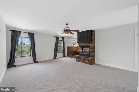 a view of patio with a table and chairs under an umbrella