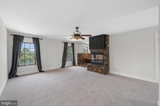 a view of patio with a table and chairs under an umbrella