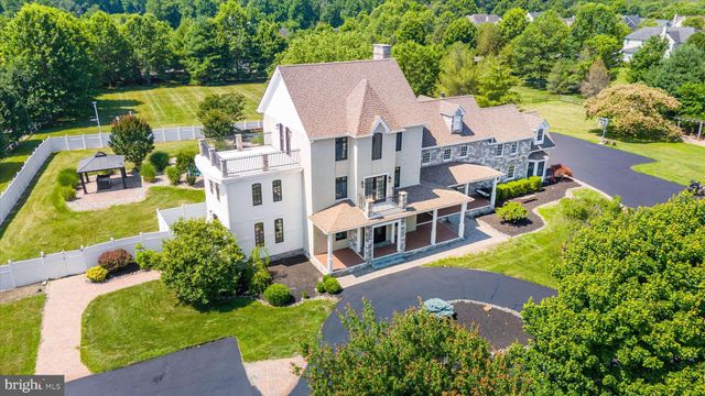 an aerial view of a house with a garden and swimming pool