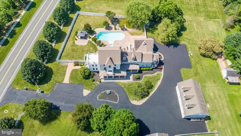 a open kitchen with granite countertop a stove top oven a sink dishwasher and a fireplace with wooden floor