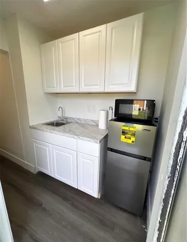 a kitchen with a sink a stove and cabinets