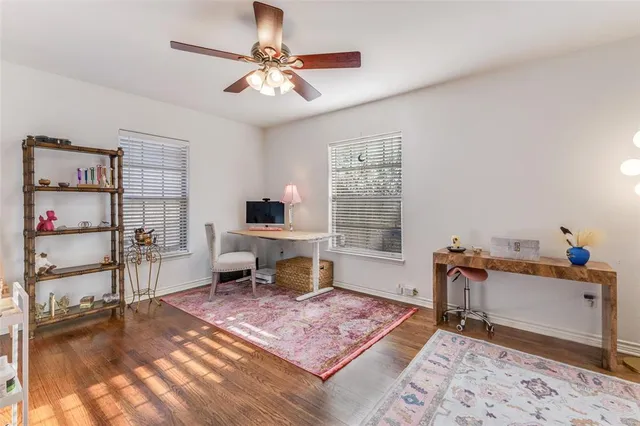 a living room with furniture a flat screen tv and a table