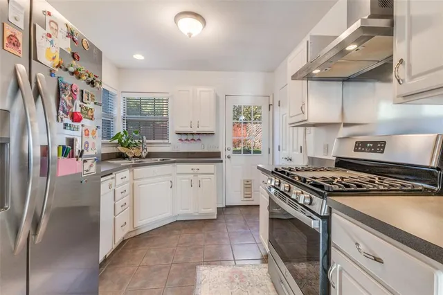 a kitchen with stainless steel appliances granite countertop a stove and a sink