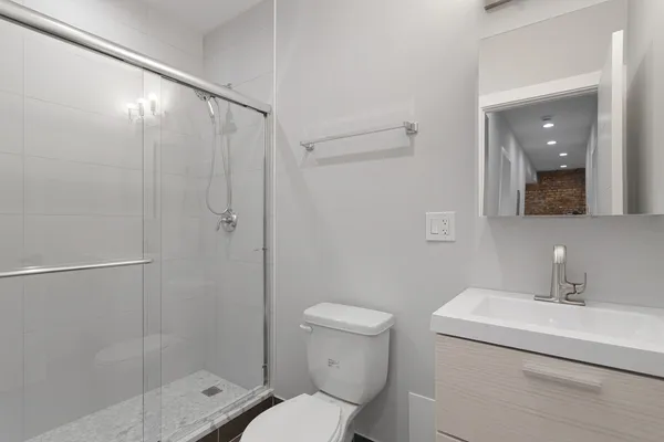 a bathroom with a sink toilet and shower