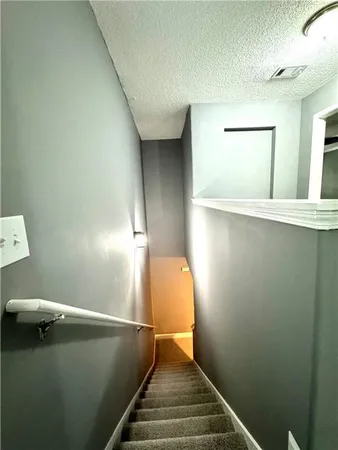 a view of a hallway with wooden floor and a ceiling fan