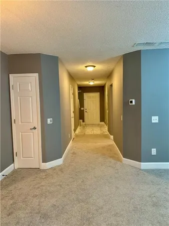 a view of a big room with closet and windows