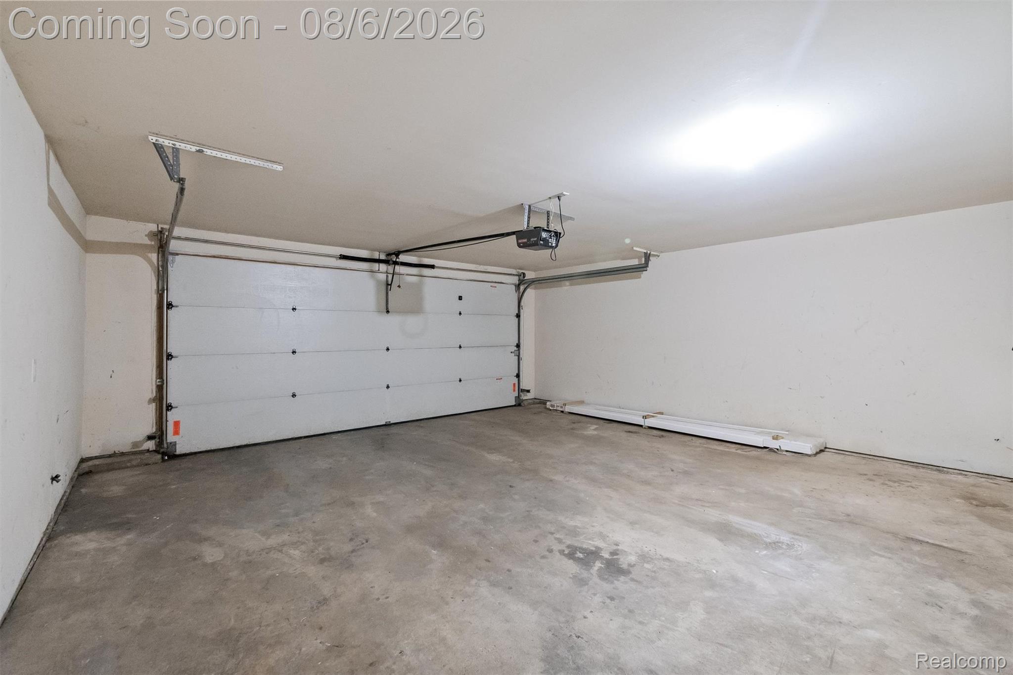 4427 Hannan Road Wayne, MI 48184 - Photo 28 of 33 Spacious two-car garage featuring an automatic overhead door system, concrete flooring, and ample ceiling height