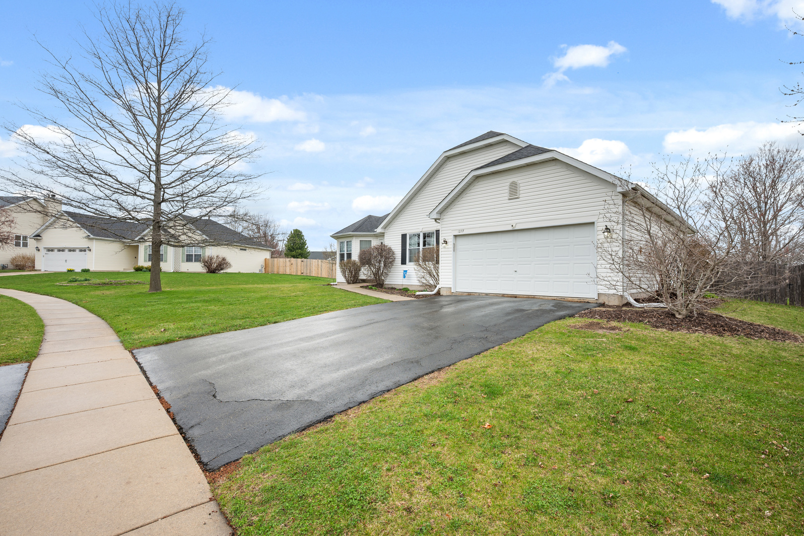 1277 Ryan Court DeKalb, IL 60115 - Photo 33 of 37 a front view of a house with a yard and garage