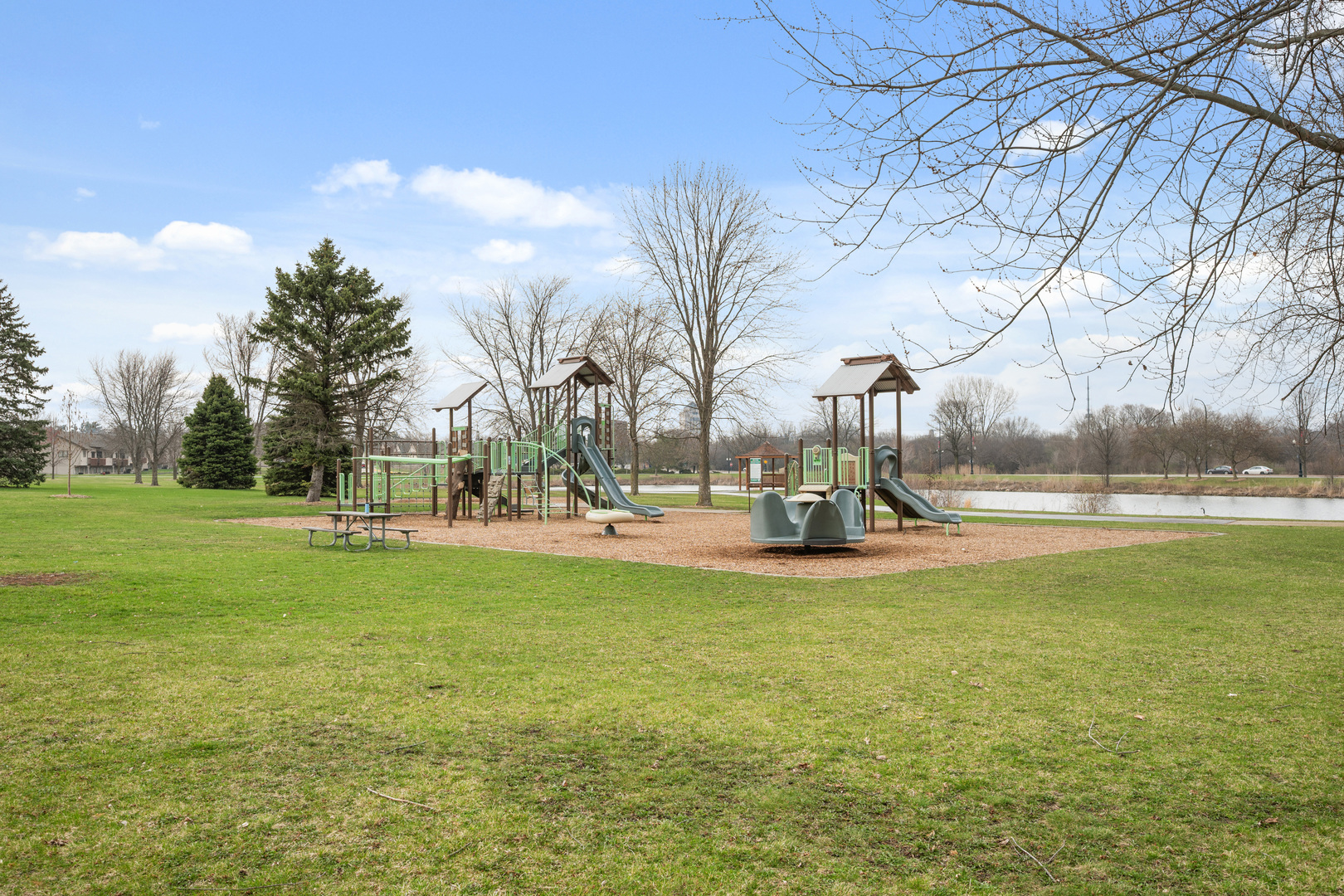 1277 Ryan Court DeKalb, IL 60115 - Photo 37 of 37 a view of a lake with a building and a big yard