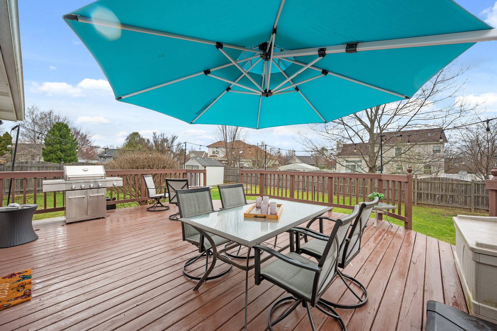 1277 Ryan Court DeKalb, IL 60115 - Photo 5 of 37 a view of a roof deck with table and chairs under an umbrella