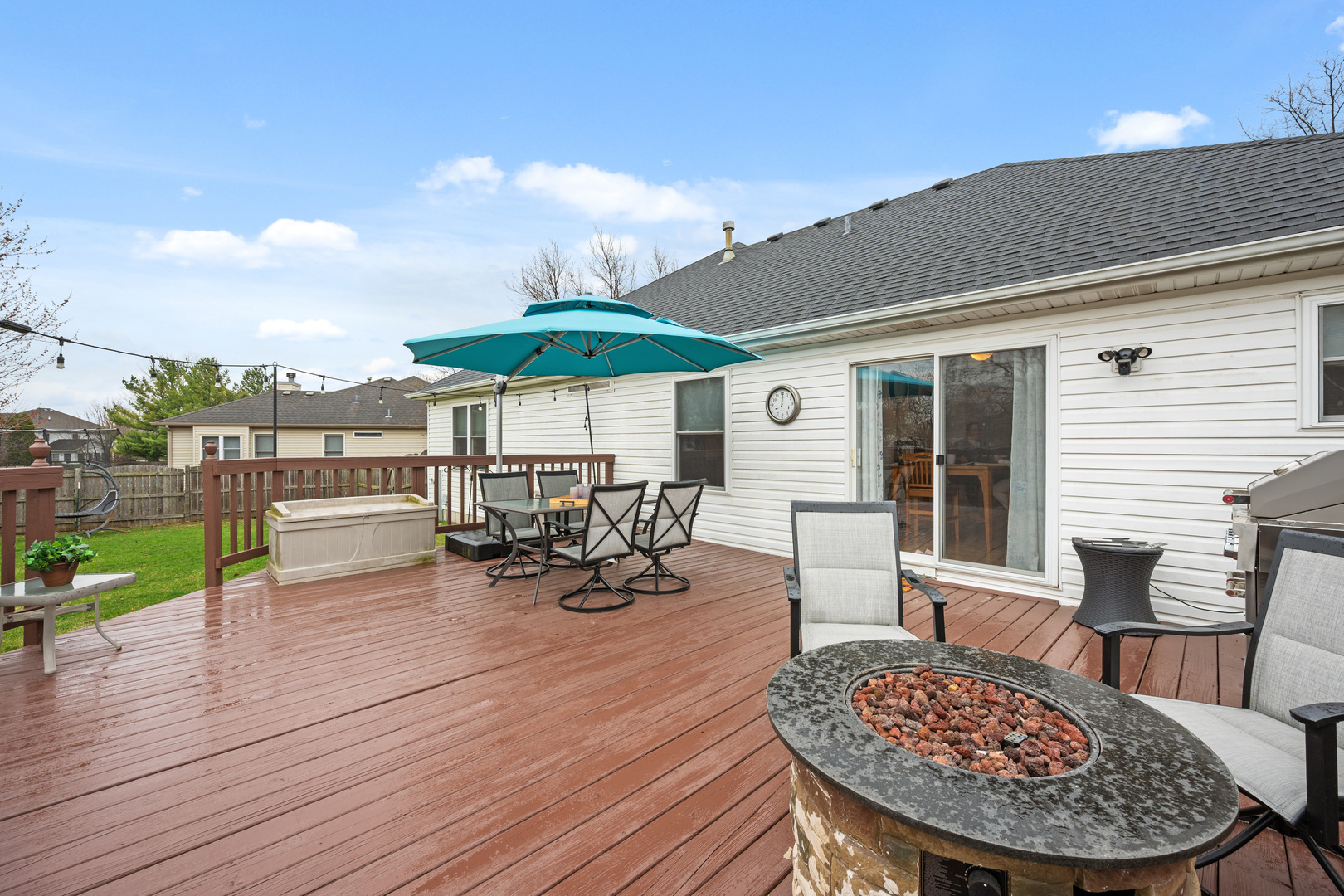 1277 Ryan Court DeKalb, IL 60115 - Photo 7 of 37 a view of a patio with table and chairs under an umbrella with wooden floor