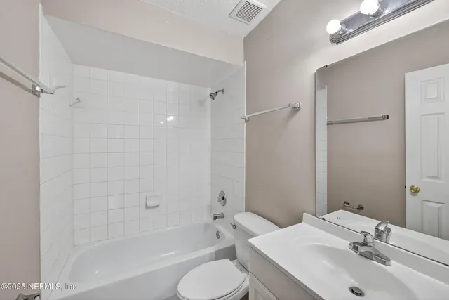 a bathroom with a sink toilet tub and shower